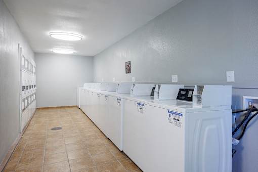 A row of washing machines in a laundromat.