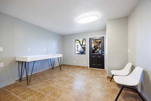 A room with a white table and a white chair.