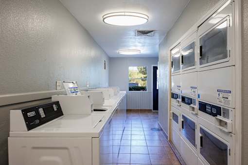 A row of washing machines in a laundromat.