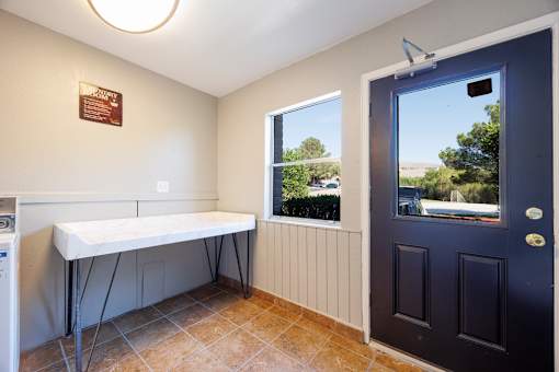 A room with a table and a window with a view of the outside.