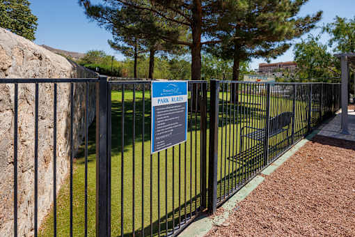 A sign on a fence that says Park Rules.