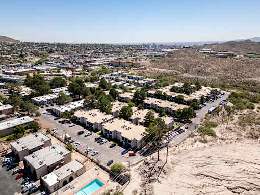 A bird's eye view of a residential complex with a swimming pool.