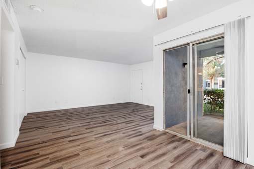 A room with a sliding glass door leading outside.
