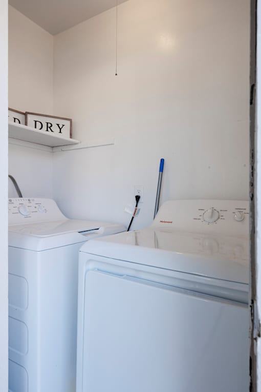 A white dryer is next to a white washing machine.