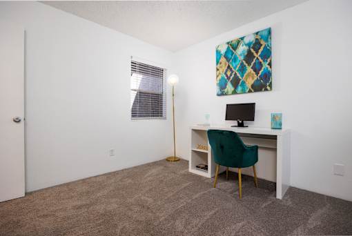 A room with a desk and a chair.
