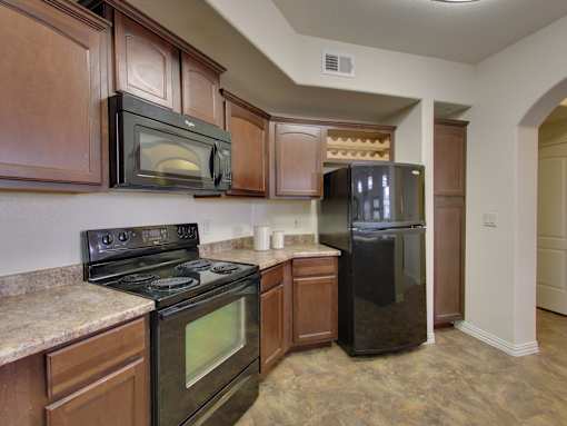 A kitchen with a black stove and microwave.