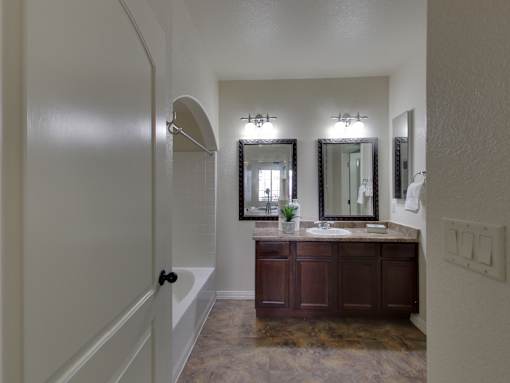 A bathroom with a vanity and a mirror.