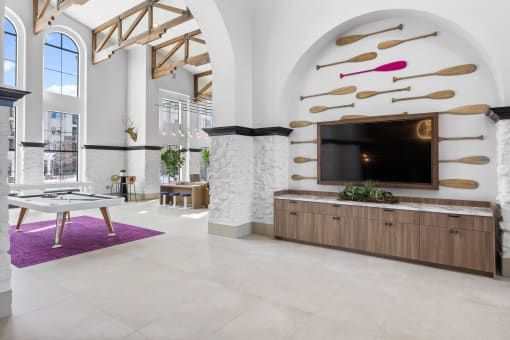 a living room with a tv and a table at Terracina, Colorado 80020
