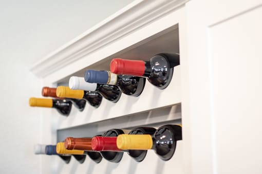 a row of wine bottles hanging in a wine rack at Terracina, Broomfield, 80020