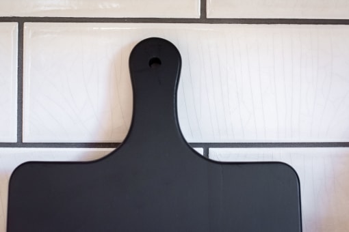 a black serving board with white tiles in the background at Terracina, Colorado 80020