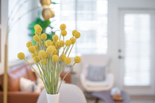 a vase of yellow flowers in a living room at Terracina, Colorado