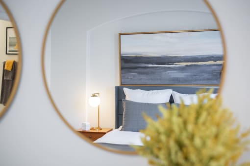 a bedroom with a bed and a mirror on the wall at Terracina, Broomfield, CO