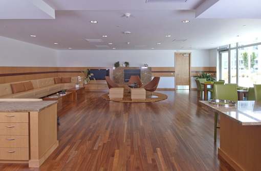 A large open space with wooden floors and furniture at The Grand Apartments, Oakland, CA, 94612