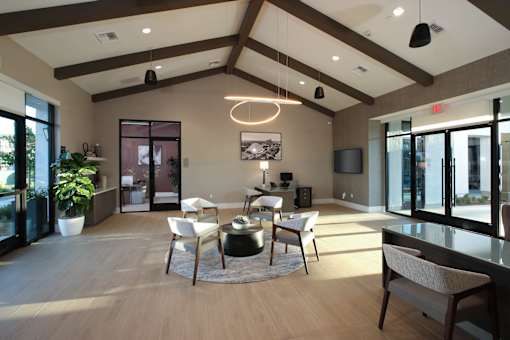 Clubroom with a large window and a dining table set up.