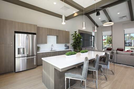 Clubroom with a large island and grey chairs.