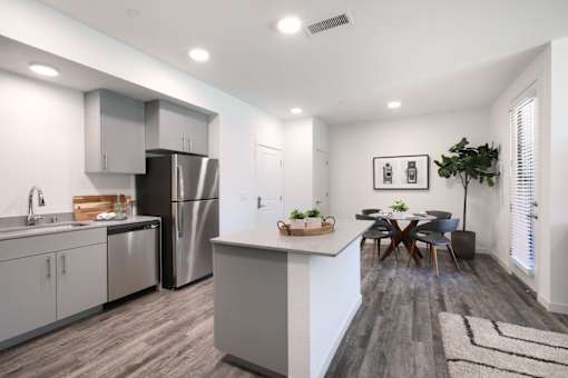 A modern kitchen with a dining table and chairs.