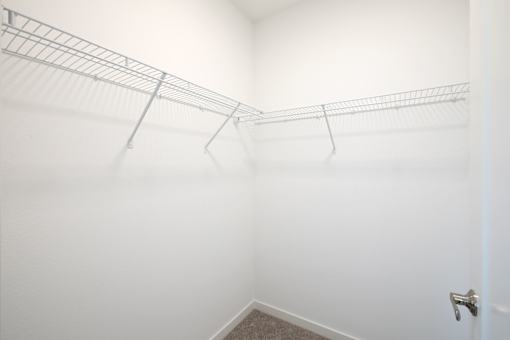 A white wall with a metal rack on it.