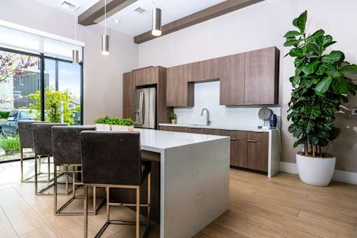 A modern kitchen with a white countertop and brown cabinets.