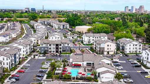 A large apartment complex with a pool in the middle.