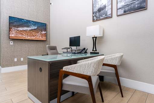 leasing office with a desk and a chair with a lamp on it.