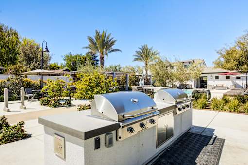 A silver outdoor kitchen with a grill