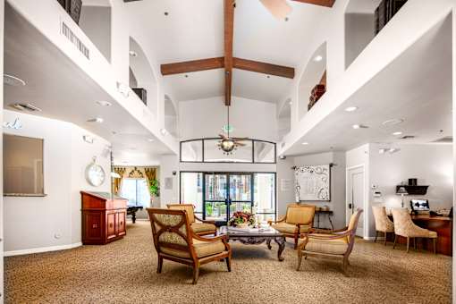 A living room with a couch, chairs, and a coffee table.