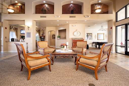 A set of four chairs are arranged around a coffee table in a room.