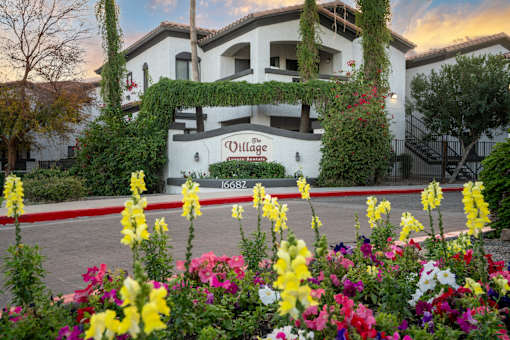 A white building with a sign that says Villas.