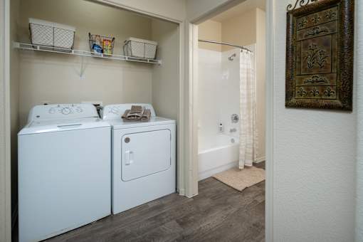 A small laundry room with a washer and dryer.