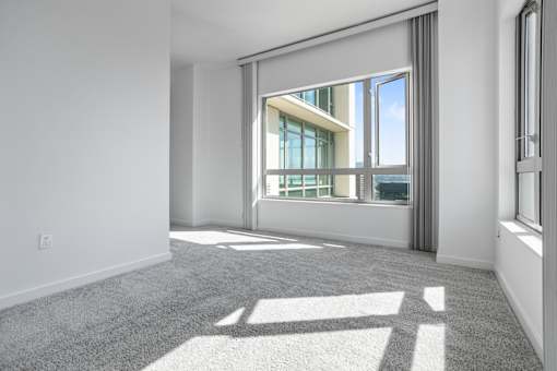 A sunny day with a view of the sky through a window at The Grand Apartments, Oakland, CA, 94612