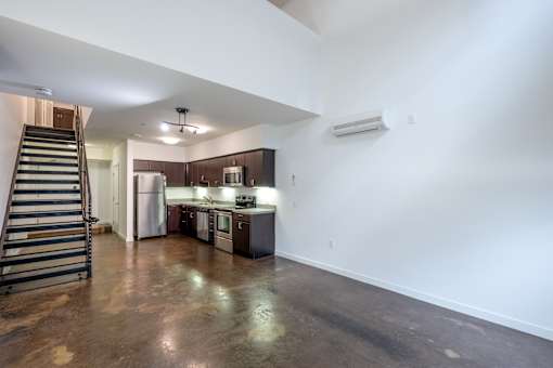 Apartment with white walls and stairs at The Grand Apartments, Oakland 94612