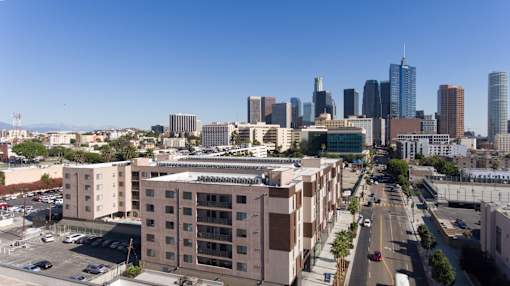 A cityscape with tall buildings and a clear blue sky at Wilshire Valencia Apartment, Los Angeles, CA, 90017