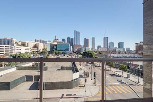 A cityscape with a clear blue sky and buildings of various heights at Wilshire Valencia Apartment, Los Angeles, CA