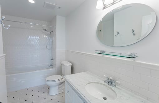 a white bathroom with a white toilet and a sink at Vendome Place, California