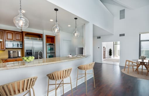 a kitchen with a bar and chairs in a house at Vendome Place, San Jose, CA 95110