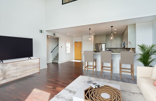 a living room and dining room with a television and a kitchen at Vendome Place, California 95110