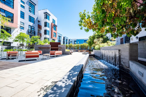 Apartments San Francisco, CA - Venue - Outdoor Courtyard with Plenty of Seating and Trees, Surrounded by a Decorative Fountain with a Walking Path