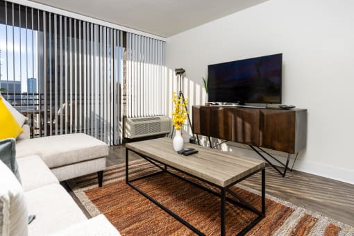 livingroom with seating, flat screen TV, entertainment center and large windows at Vera Cortez Hill, San Diego, California