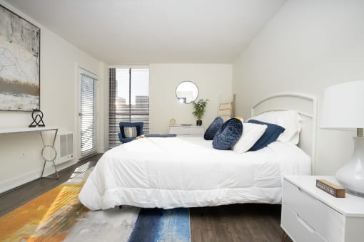 Bedroom with white bed, white night stand and light artwork  on the wall at Vera Cortez Hill, San Diego, 92101
