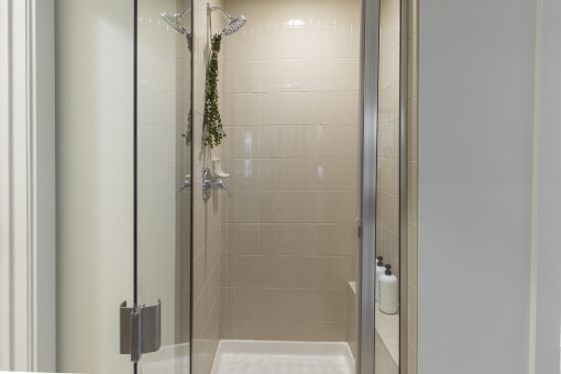 a shower with a glass door in a bathroom at Waterford RiNo, Colorado