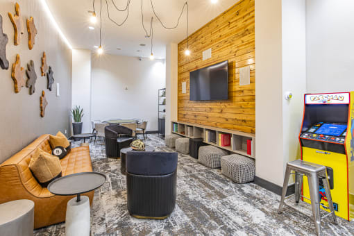 Gameroom with arcade and seating at Waterford RiNo, Denver