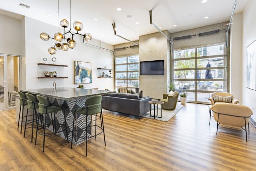 Clubroom with lounge seating and a TV at Waterford RiNo, Denver, CO 80216