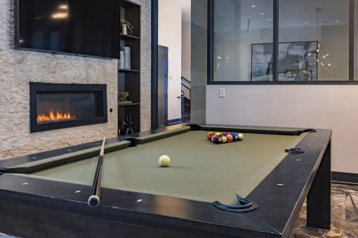 a pool table in the clubroom with a firepit at Waterford RiNo, Colorado 80216