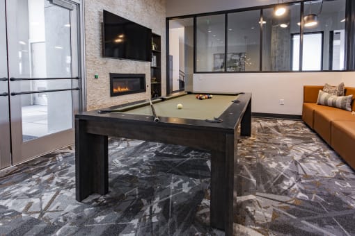 a pool table in the clubroom with a firepit at Waterford RiNo, Colorado