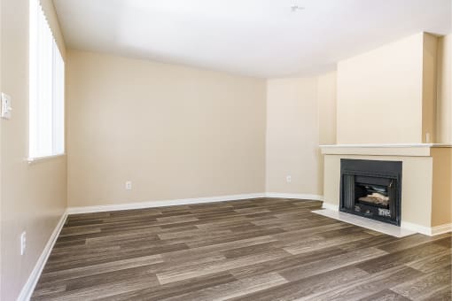 renovated floor plan with plank style flooring and fireplace