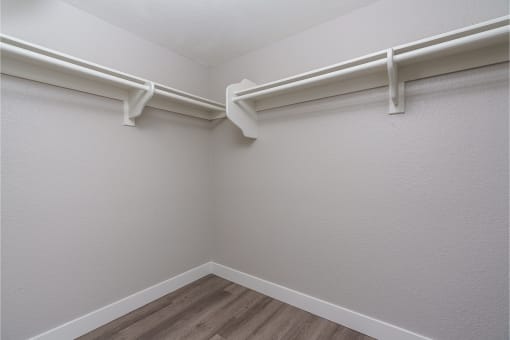 renovated walk in closet with plank style flooring