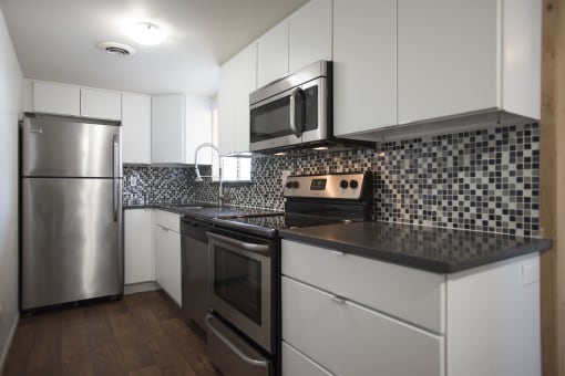 Scottsdale Apartments For Rent - Full-Equipped Kitchen With New Cabinets, Glass Tile Back-Splash, Stainless Steel Appliances, Caesar Stone Countertops, Dishwasher,  and Wood-Style Flooring