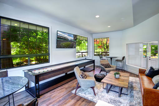 Indoor Clubhouse With Convenient Kitchenette, Flat Screen TV, and Ample Comfortable Seating at Woodlake Apartments, Washington 98034