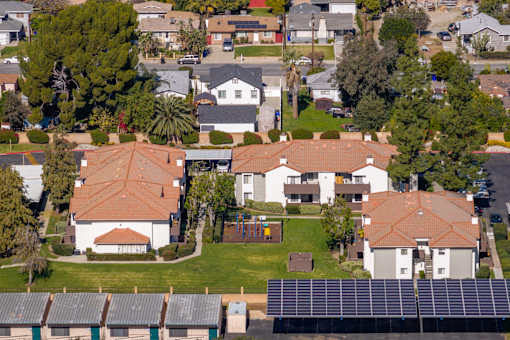 Aerial view of residential buildings with solar panels at Woodbend Apartments, Alta Loma, CA 91701