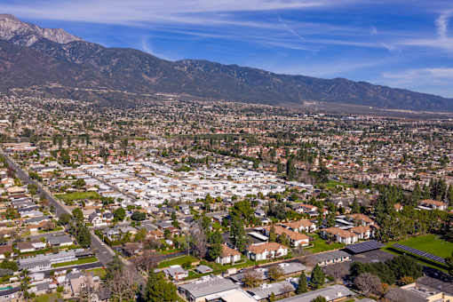 Aerial view of residential community with mountains at Woodbend Apartments, Alta Loma, CA